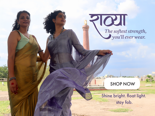 Two women in handloom golden saree and purple saree standing outdoors with shop now button