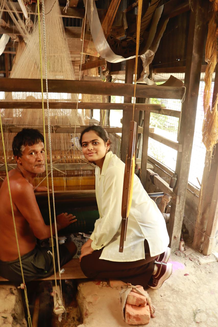 mirari life founder with an artisan and saree loom setup in the background